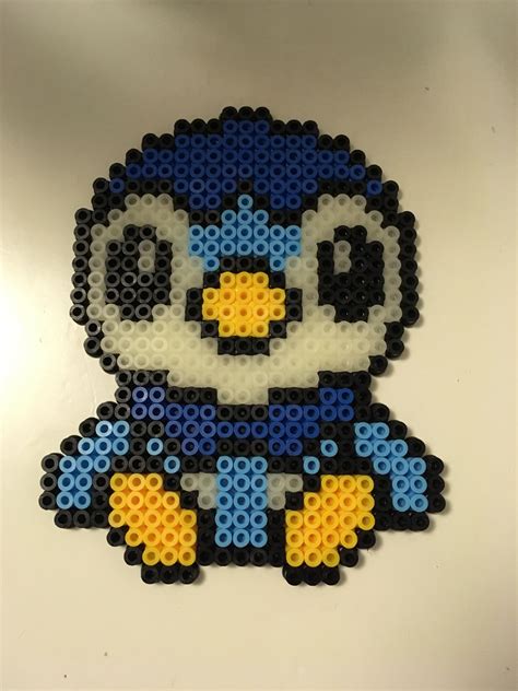An Image Of A Penguin Made Out Of Legos On A White Surface With Blue