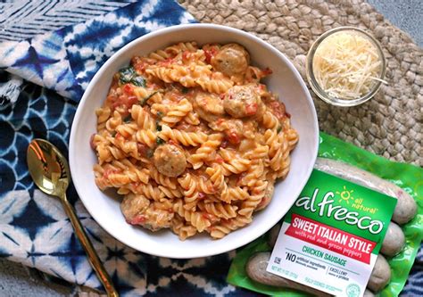 Add the chicken broth, heavy cream, diced tomatoes, and dry pasta to the pan. One Pan Cheesy Chicken Sausage Pasta | Al Fresco
