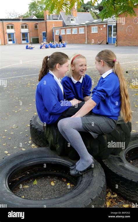 Schoolgirls In School Playground Chat During Breaktime Stock Photo Alamy