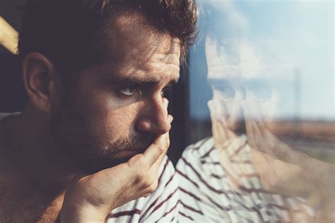 Sad Young Man Looking Through The Window Stock Photo Download Image