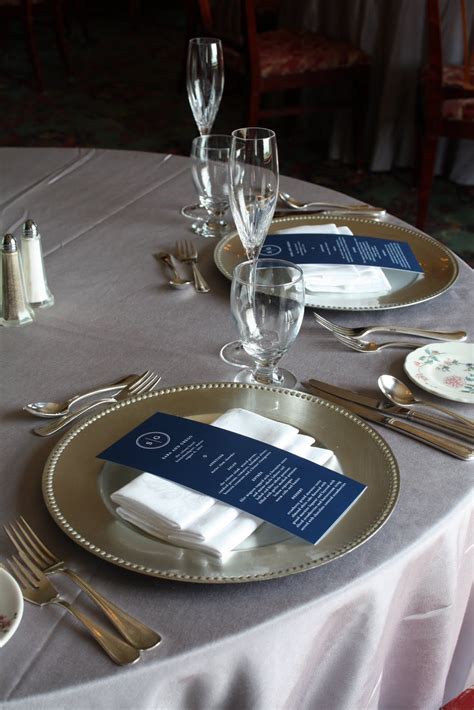 White Linens With Silver Charger Plates And A Pop Of Colour Napkins