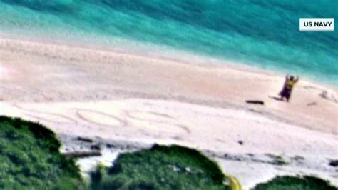 stranded boaters rescued after writing ‘sos in sand on deserted island