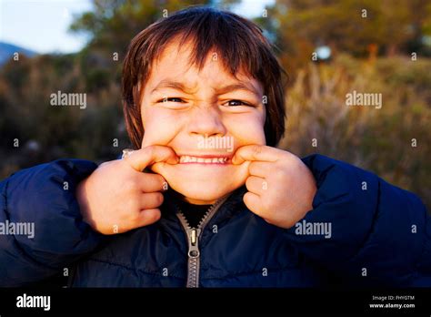 Portrait Of Little Boy Pulling Funny Faces Stock Photo Alamy