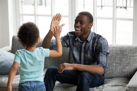Happy Black Dad And Son Giving High Five Playing At Home The Play Project
