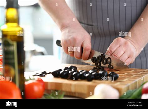 Professional Chef Cutting Black Olive Ingredient Stock Photo Alamy
