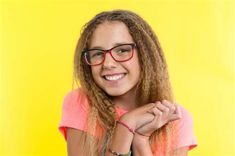 Premium Photo A Teenage Girl With Glasses Looks And Smiling