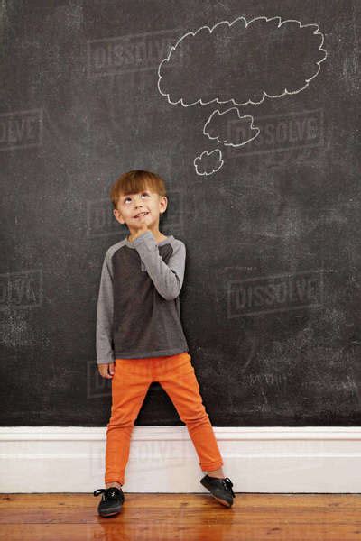 Child Thinking With A Thought Bubble On The Blackboard Full Length
