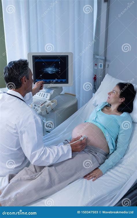 Doctor Doing Ultrasound Scan For Pregnant Woman In Hospital Stock Image