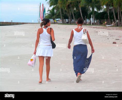 Two Young Women Walk On Pantai Cenang Beach Pulau Langkawi Island