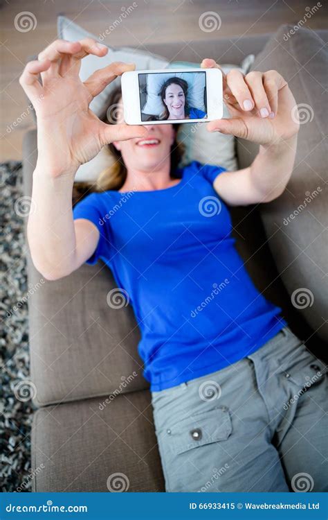 Smiling Woman Taking A Selfie On Her Mobile Phone Stock Image Image Of Pillows Woman 66933415