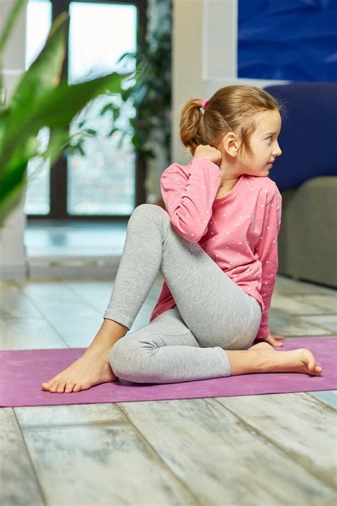 Little Girl Doing Stretching Exercises Practicing Yoga On Fitness Mat