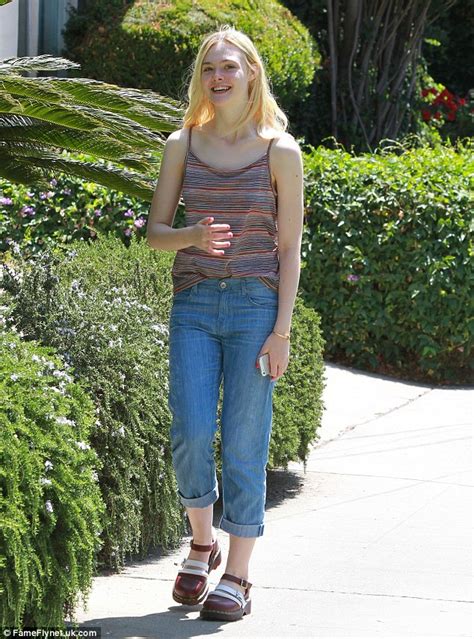 Elle Fanning Keeps It Casual In Rolled Up Jeans And Mary Janes During A