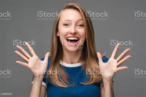 Portrait Of Young Female Smiling Happily And Spreads Her Hands To The Side Human Emotions Facial