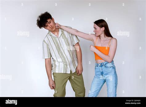 man punching woman in face