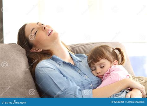 Tired Mother Sleeping With Her Baby Daughter Stock Photo Image Of