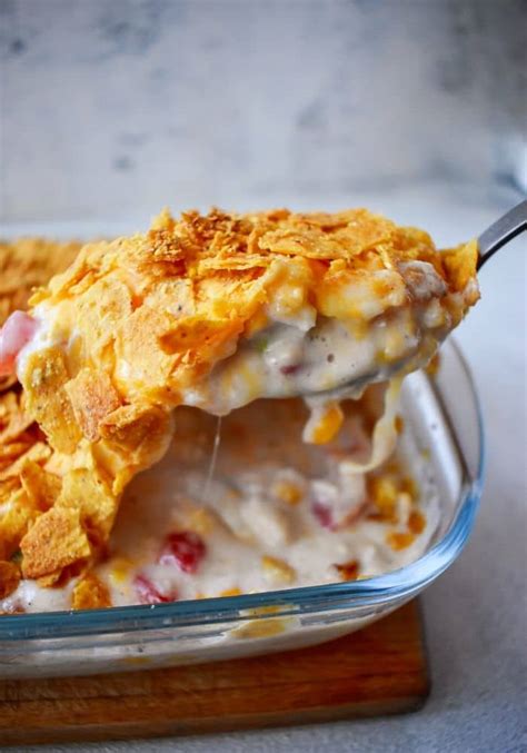 In a greased or sprayed 9x13 casserole dish, layer 1/2 of the crushed dorito's, all of the diced chicken, all of the cream of mushroom soup, all of the cream of chicken soup, all of the the rotel tomatoes, all of the shredded cheddar cheese, and the other half of the crushed dorito's. Easy Doritos Chicken Casserole - 100KRecipes