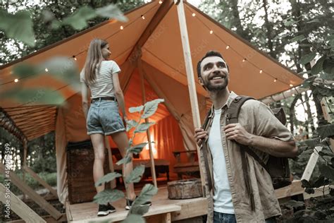 Romantic Couple Camping Outdoors And Standing In Glamping Tent Happy Man And Woman On A