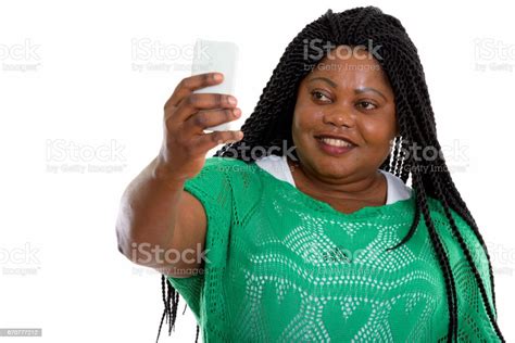 Studio Shot Of Happy Fat Black African Woman Smiling While Taking