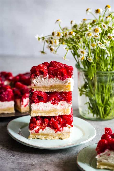 I made this and it is very yummy. raspberry cream cheese bars stacked on a plate | Raspberry ...