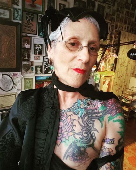 an older woman with tattoos on her chest