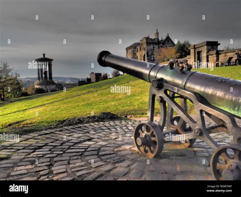 Cannon On Calton Hill With Dugald Stewart Monument In The Back Ground