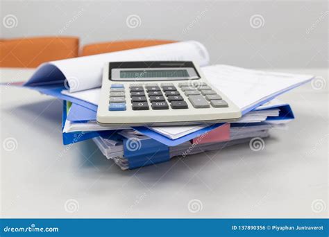 Blue File Folder With Paper Calculation On The Table In Work Office