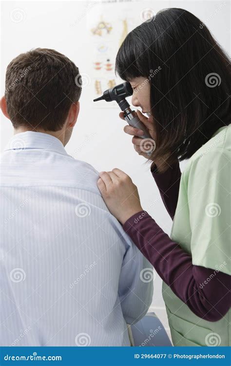 Doctor Checking Patient Ear S With Otoscope Stock Image Image Of