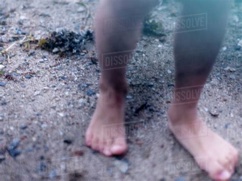 Person Standing On Sand Stock Photo Dissolve