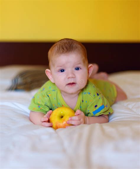 The Beautiful Baby Holding Yellow Apple Stock Photo Image Of Holds
