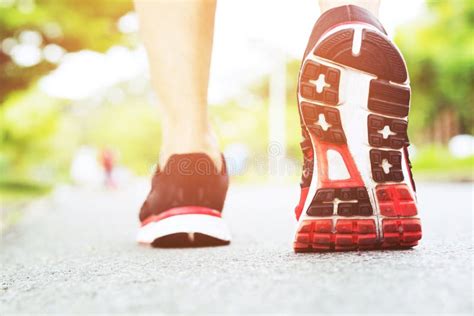 Sportsman Runner Feet Running On Road Close Up On Shoe Behind Of A Man