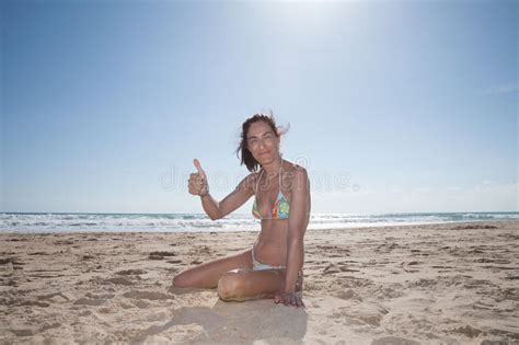 Woman Sitting In Beach Finger Up Ok Stock Photo Image Of Person Sand