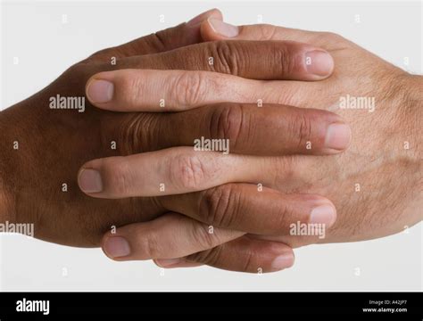 Close Up Of Two Hands Interlocking Stock Photo Alamy
