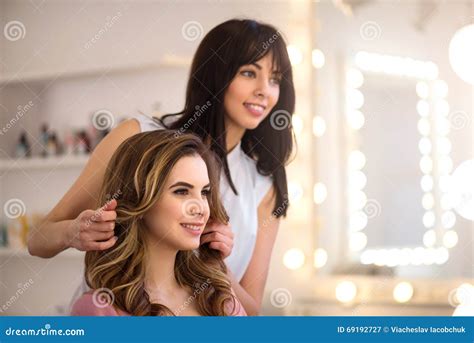 Positive Professional Hairdresser Working On The Salon Stock Image