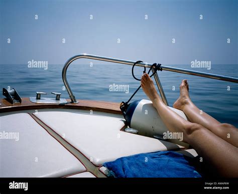 A Woman Sunbathing On A Boat Deck Stock Photo Alamy