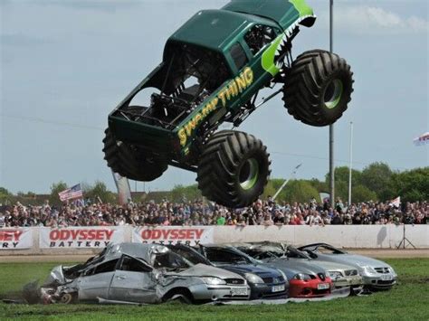 Swamp Thing Monster Truck Catching Some Air Crushing Some Cars