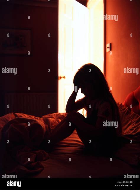 Silhouette Of A Young Girl In Despair In Her Bedroom A Light Shines
