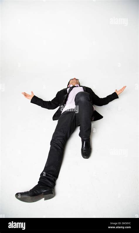 Professional Young Man Laying On Ground With Arms Outstretched Stock