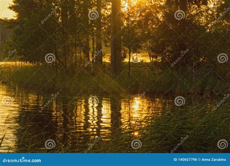 The Setting Sun Reflected In The Lake Stock Photo Image Of Breaking