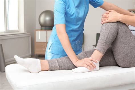 Physiotherapist Working With Patient In Clinic Rehabilitation Therapy