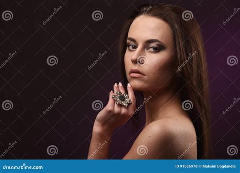 Beautiful Brunette Woman With Professional Makeup And Hairstyle Showing