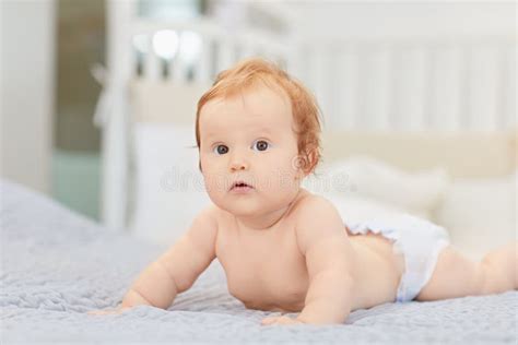 A Smiling Baby Is Lying On A Bed In A Room Stock Image Image Of Body