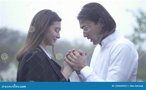 Handsome Man Warms Hands Of Female With His Breath Outdoors Guy And Girlfriend Spending Time