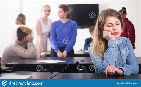 Young Girl Student Feeling Uncomfortable At Break Between Classes Stock