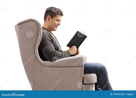 Young Guy In An Armchair Reading A Book Stock Image Image Of