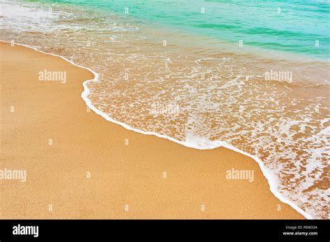 Wave Of Azure Sea On Sandy Beach Sea Surface Background Stock Photo