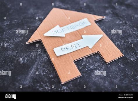 house icon with mortgage or rent signs pointing in opposite directions