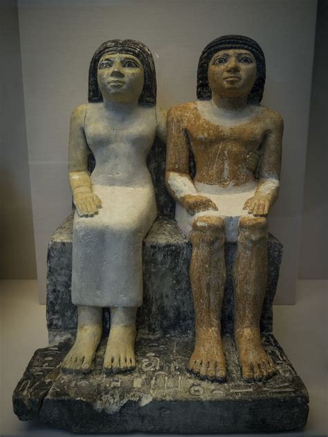 two statues sitting next to each other on display