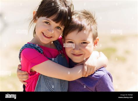 Two Happy Kids Hugging Outdoors Stock Photo Alamy