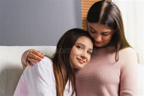 Two Pretty Stylish Cool Girls Couple Dating In Love Hugging Each Other Sitting On The Sofa At
