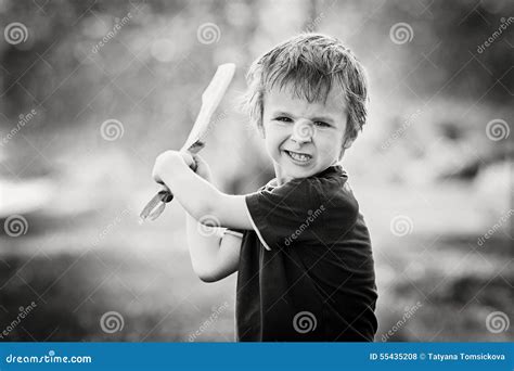 Angry Little Boy Holding Sword Glaring With A Mad Face At The Stock